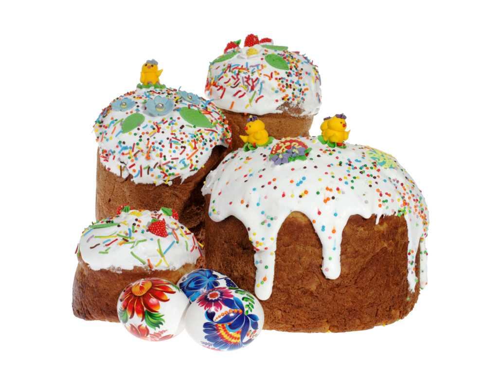Пасхальные куличи с сахарными цыплятами и расписанными яйцами на белом фоне