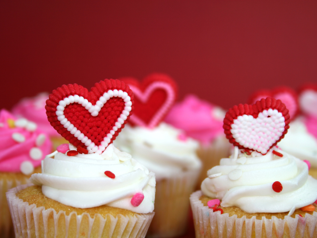 Cupcakes with cream and red hearts for Valentine's Day