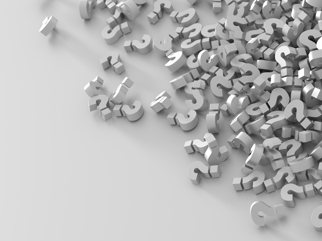 Много знаков вопроса на серой поверхности 