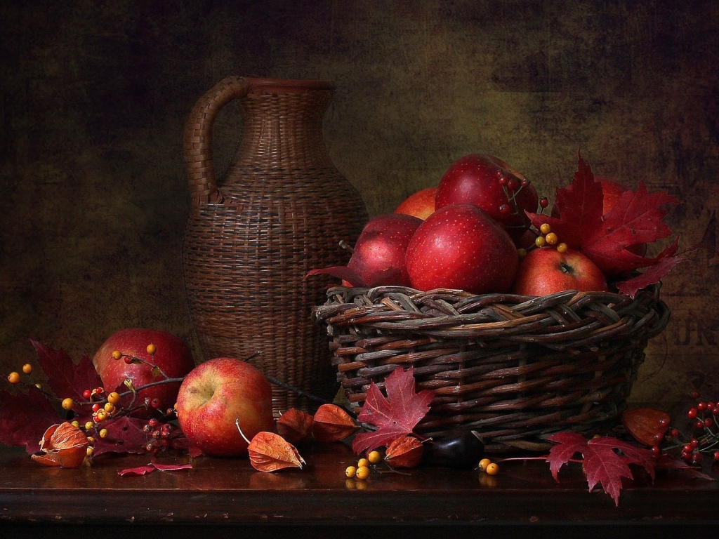 Корзина с красными яблоками на столе с кувшином 