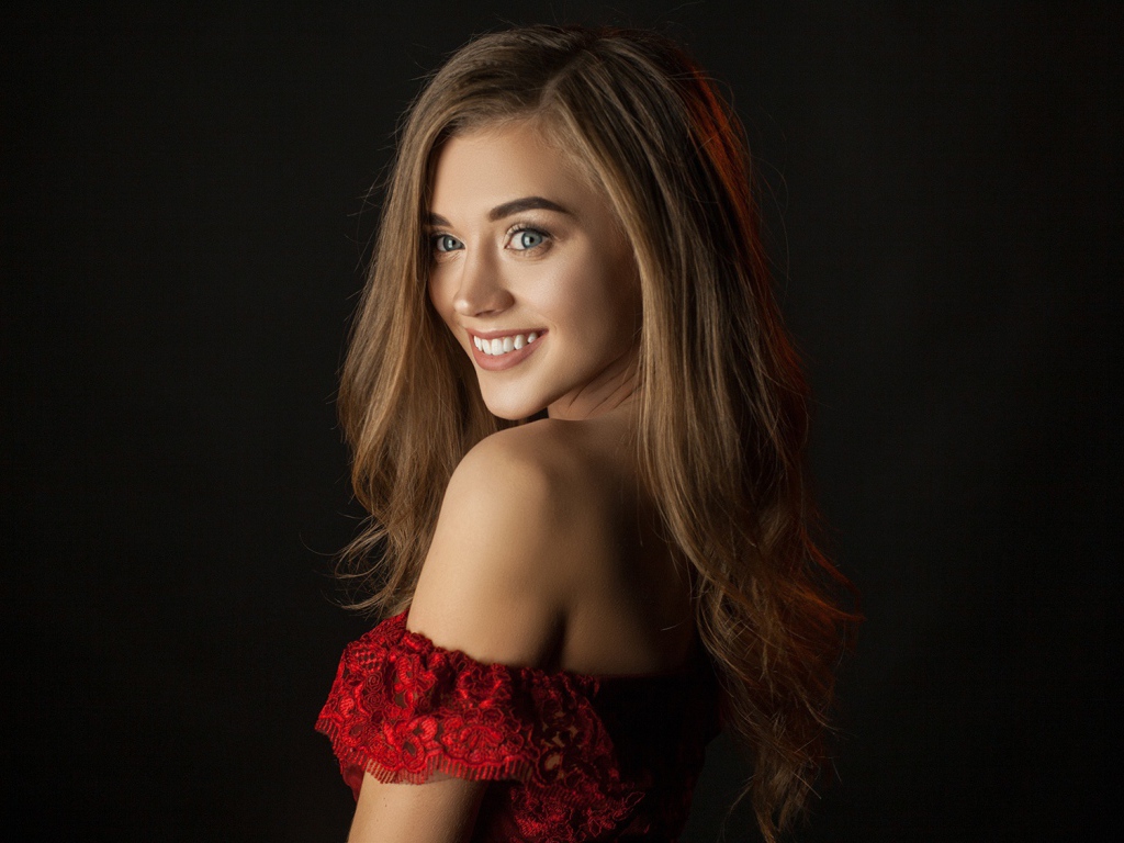 Милая улыбающаяся девушка на черном фоне