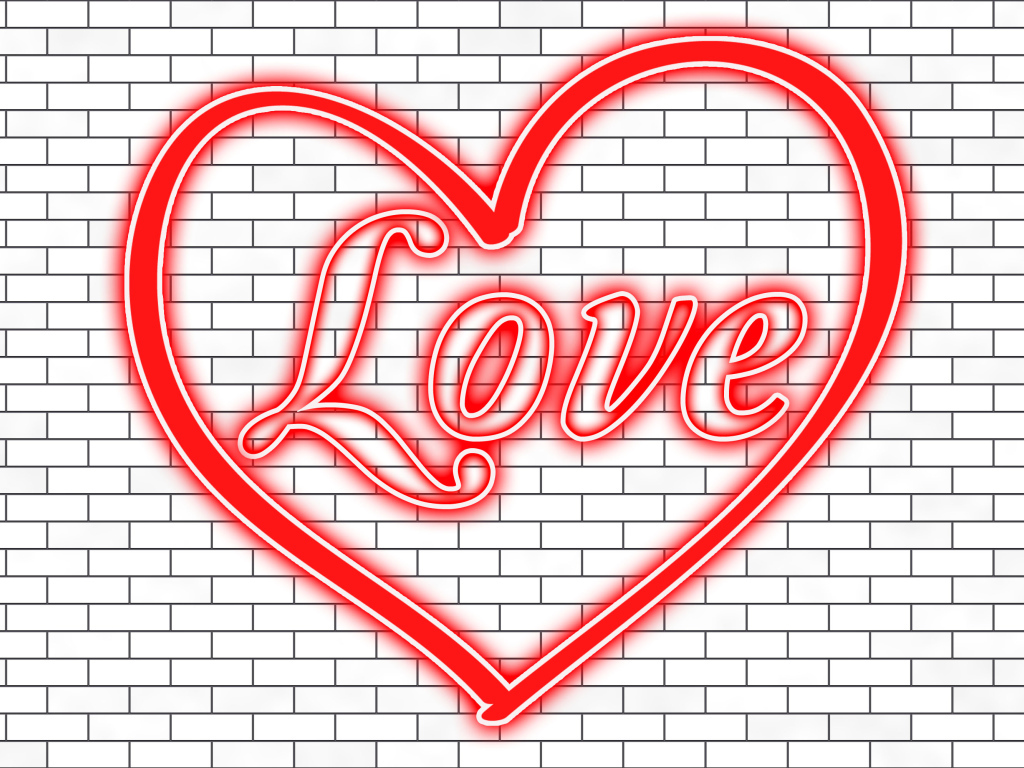Красное сердце с надписью Любовь на кирпичной стене