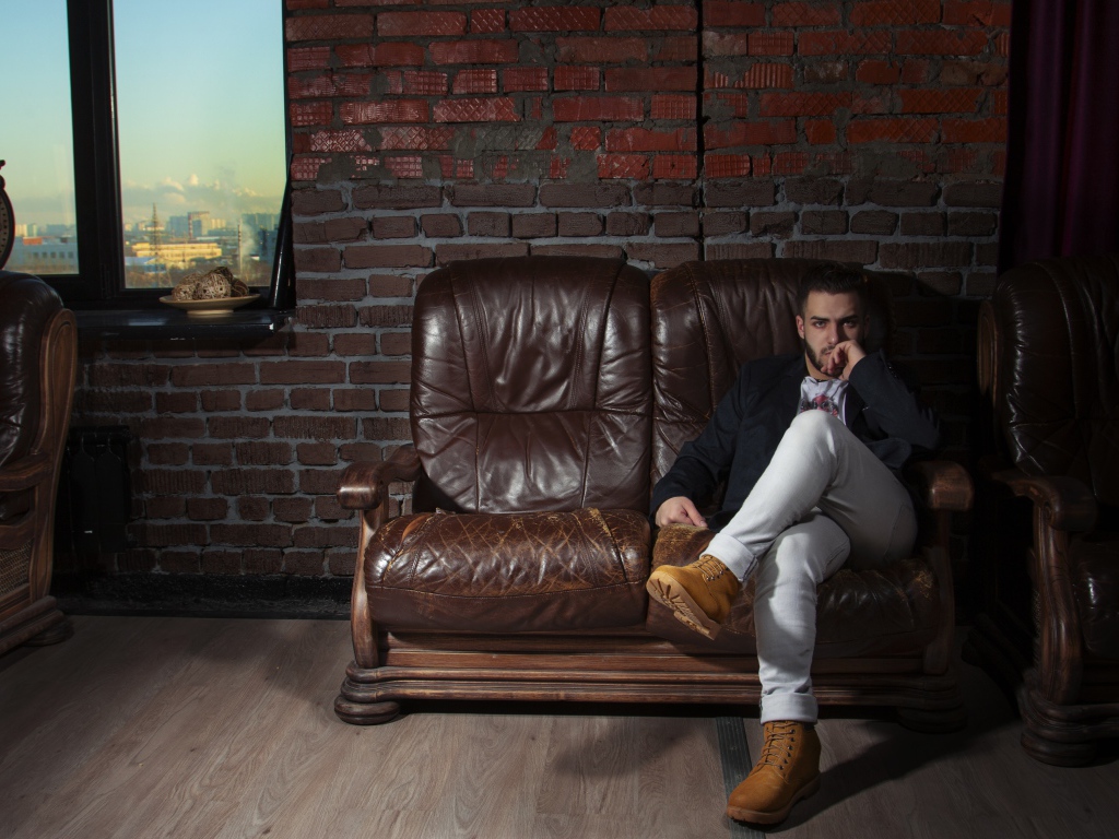 Stylish man sitting in a leather chair