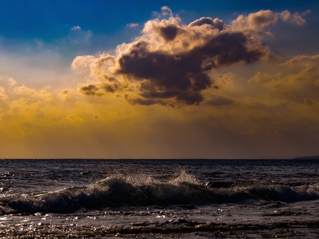 Белое облако в небе над морем