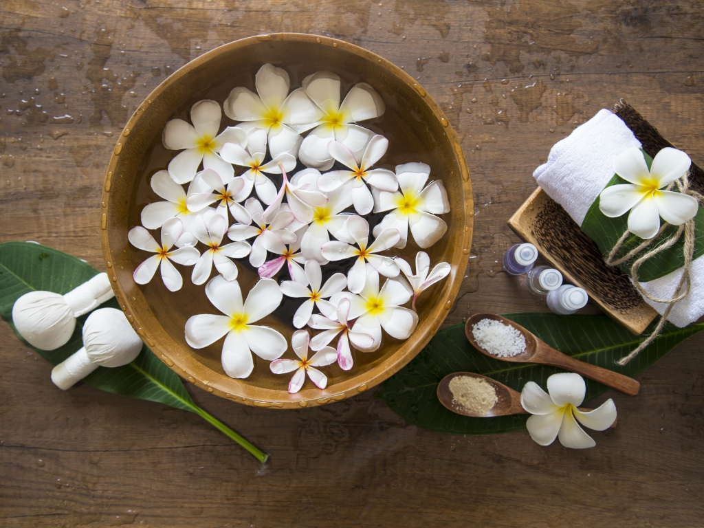 Цветы плюмерии в чаше с водой для SPA процедур 