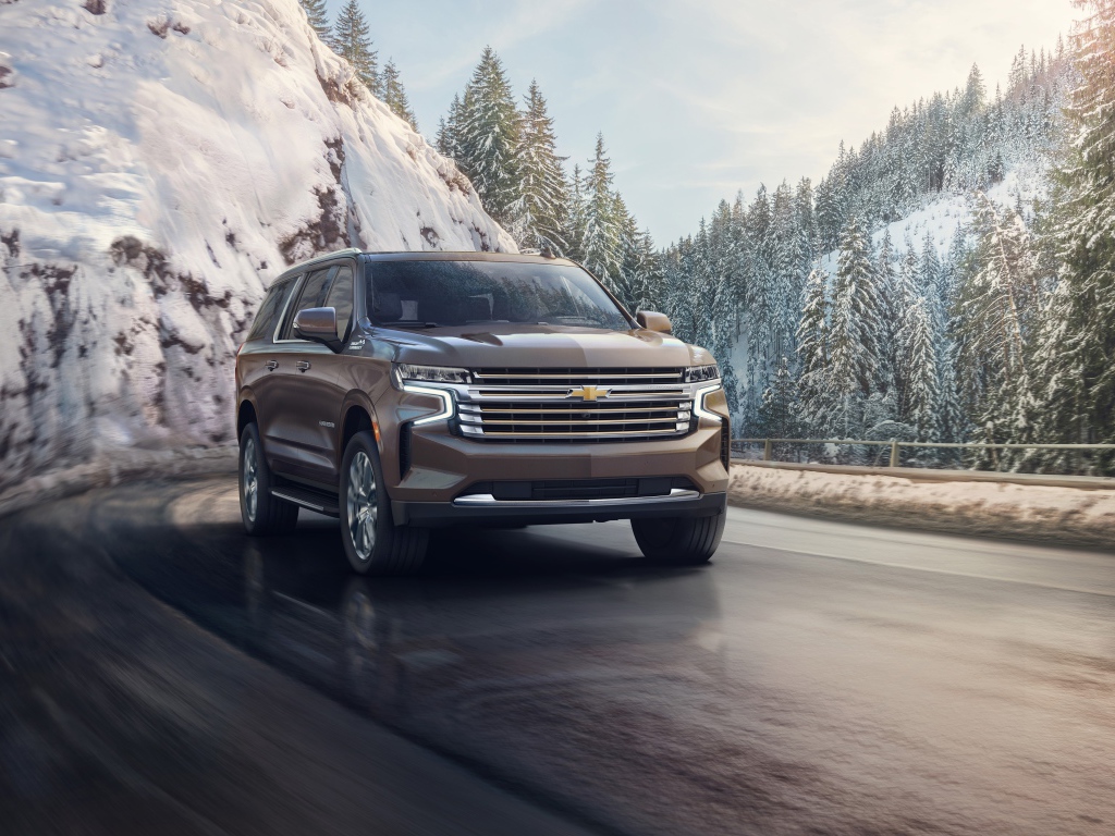 Внедорожник Chevrolet Suburban на фоне заснеженного леса, 2021 года