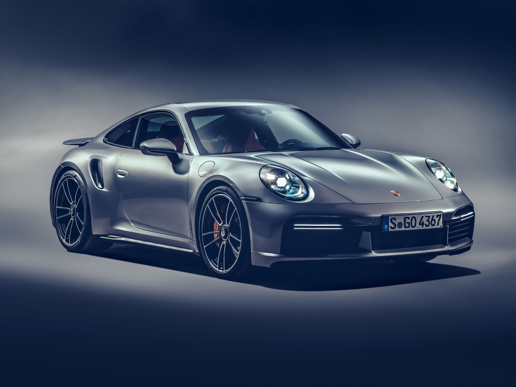 Автомобиль Porsche 911 Turbo S 2020 года на сером фоне