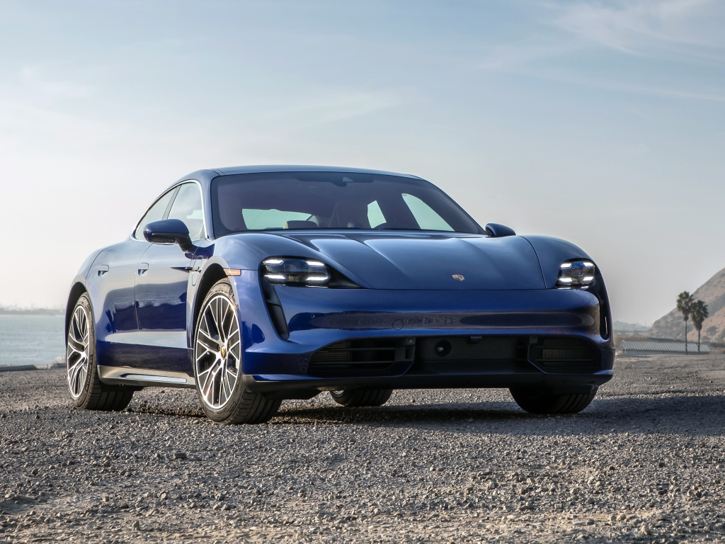 Синий автомобиль  Porsche Taycan Turbo, 2020 года у океана