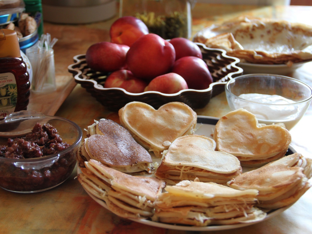 Блины с начинкой на столе с нектарином