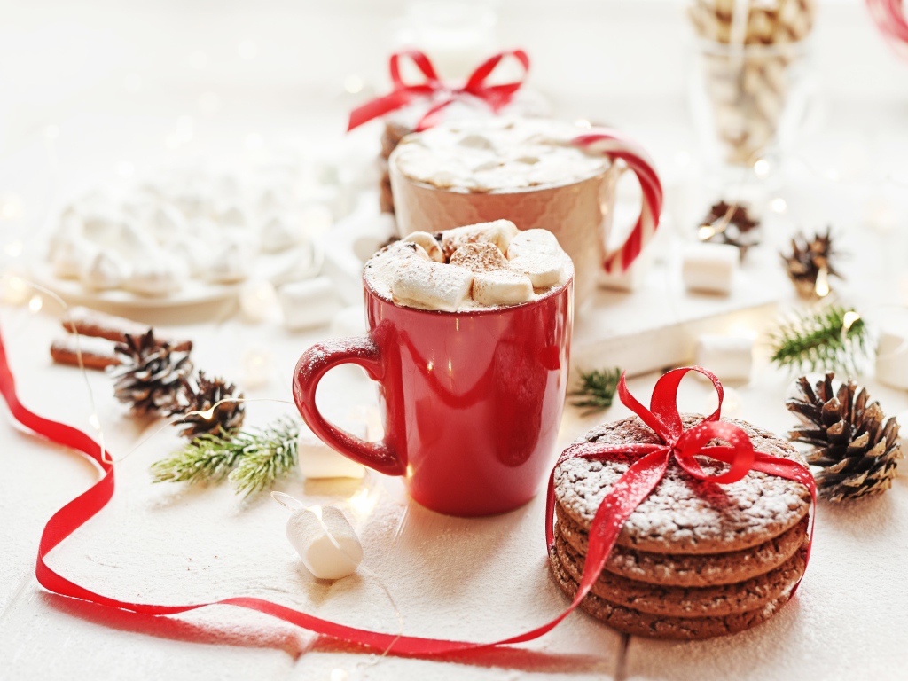 Чашки напитка с маршмеллоу на столе с печеньем