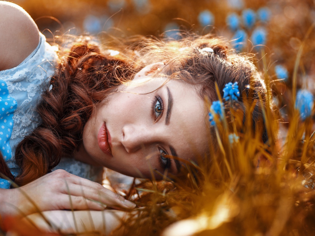Красивая девушка на земле с мускариками