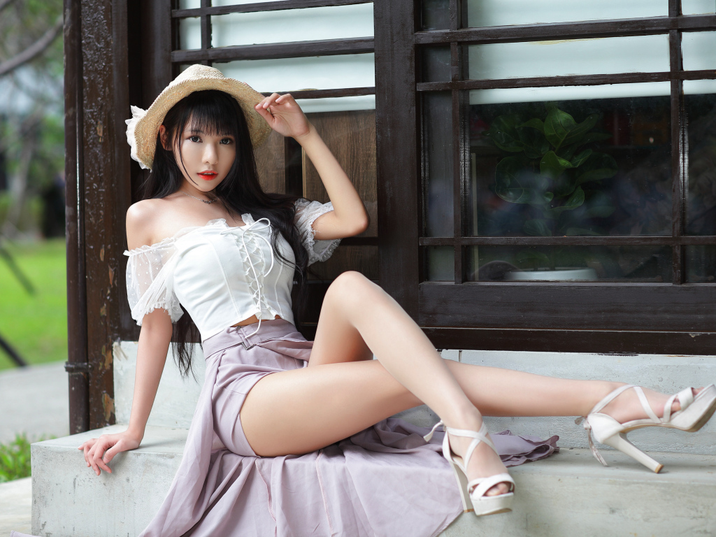 Slim Asian with long legs by the window