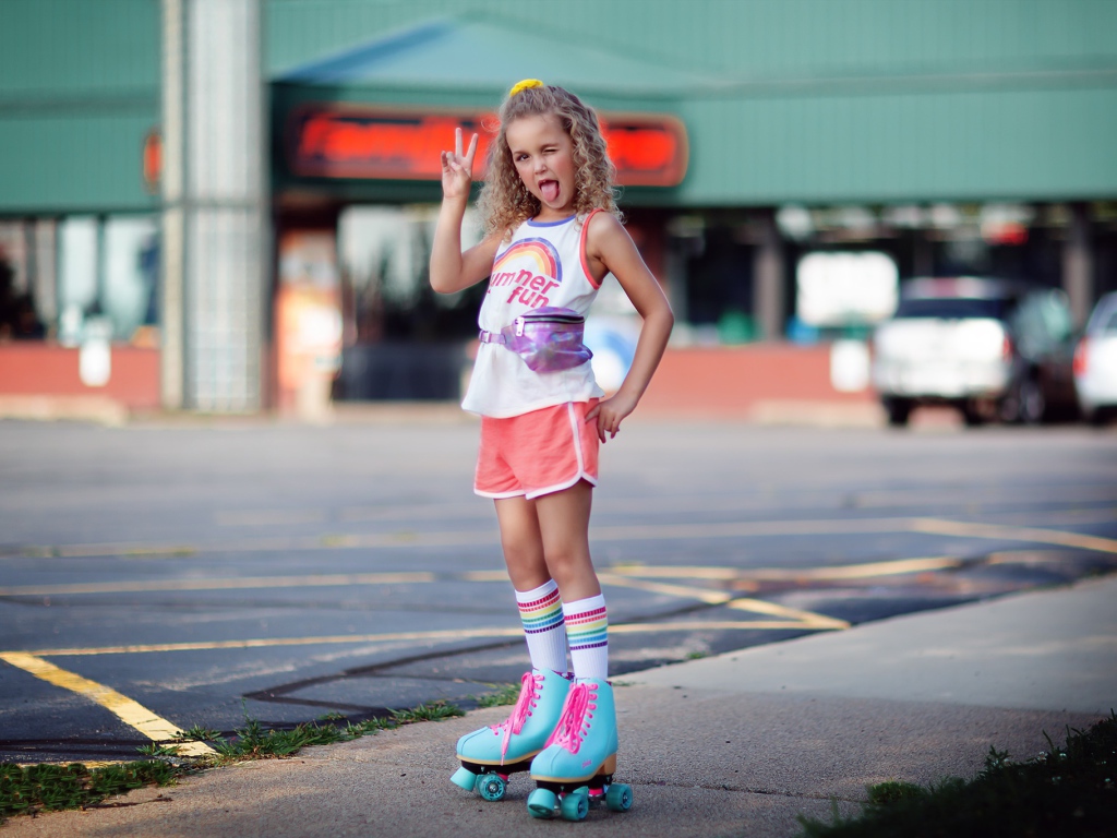 Модная маленькая девочка на роликах 