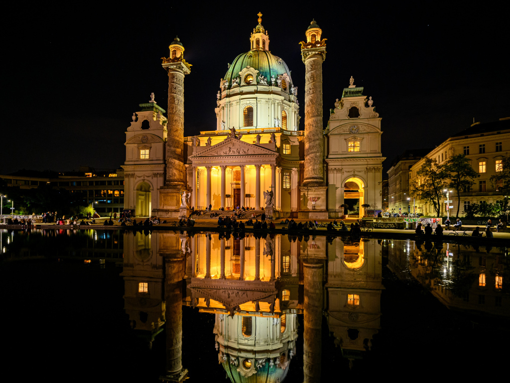 Старая церковь Карлскирхе ночью отражается в воде, Вена. Австрия