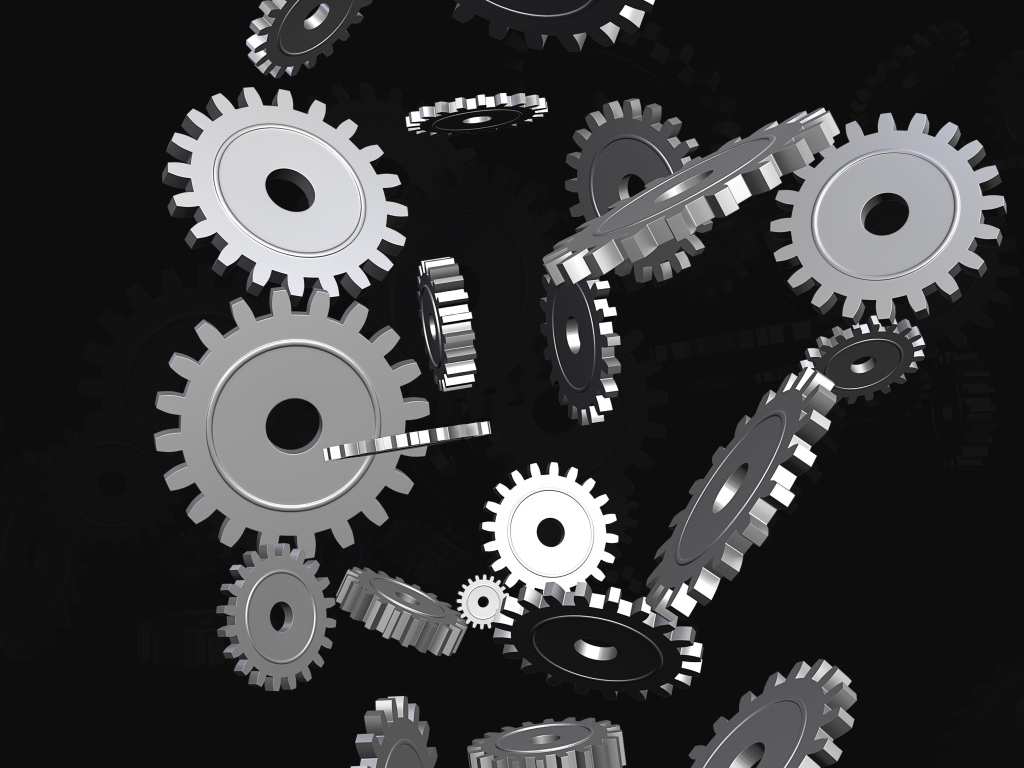 Металлические шестеренки в воздухе на черном фоне