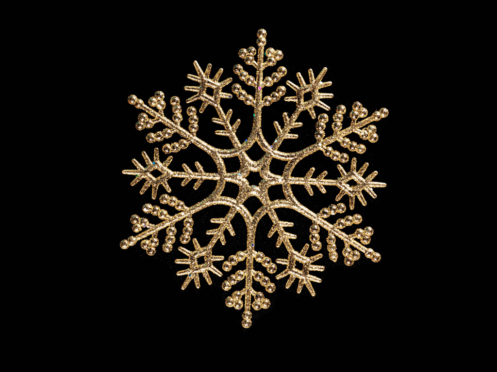 Красивая золотистая снежинка на черном фоне