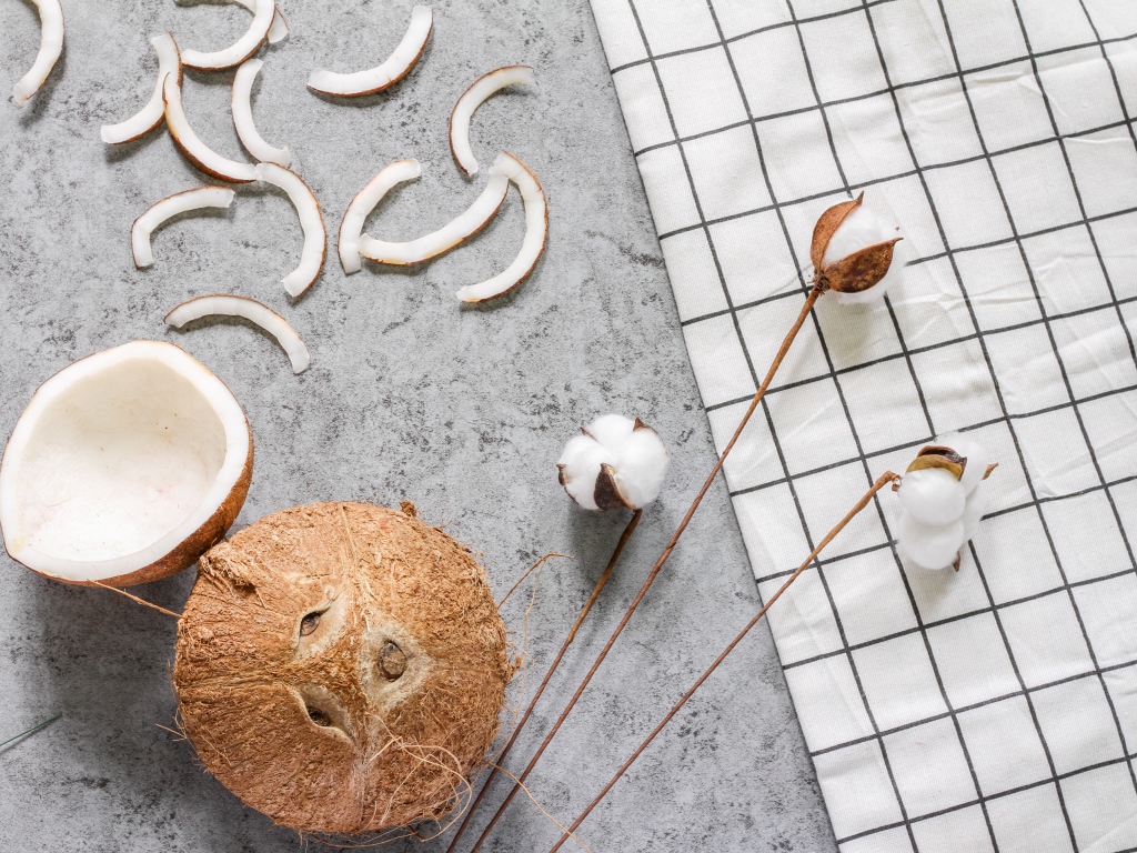 Кокос с веточками льна на столе 