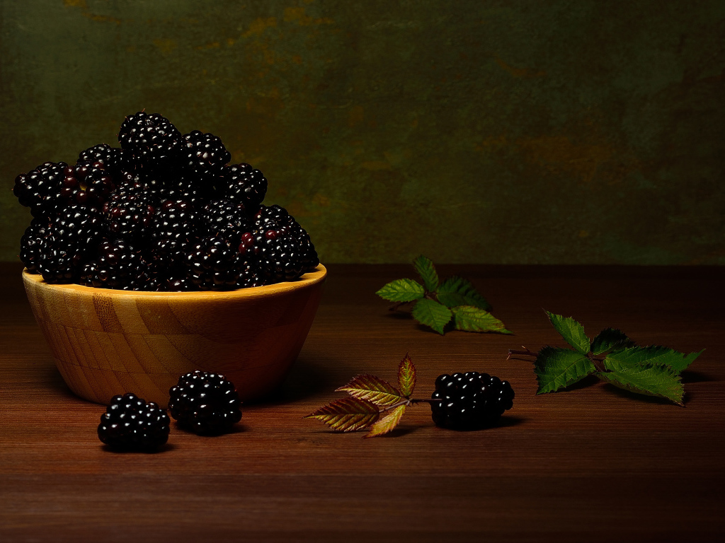 Крупная спелая ежевика в деревянной миске