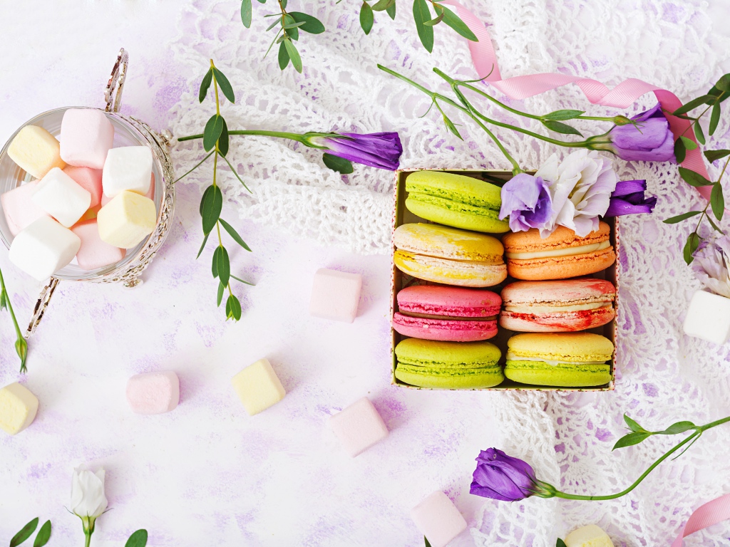 Десерт макарон на столе с кружевной салфеткой и маршмеллоу