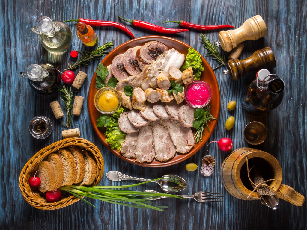 Appetizing cold cuts on the table with spices and bread