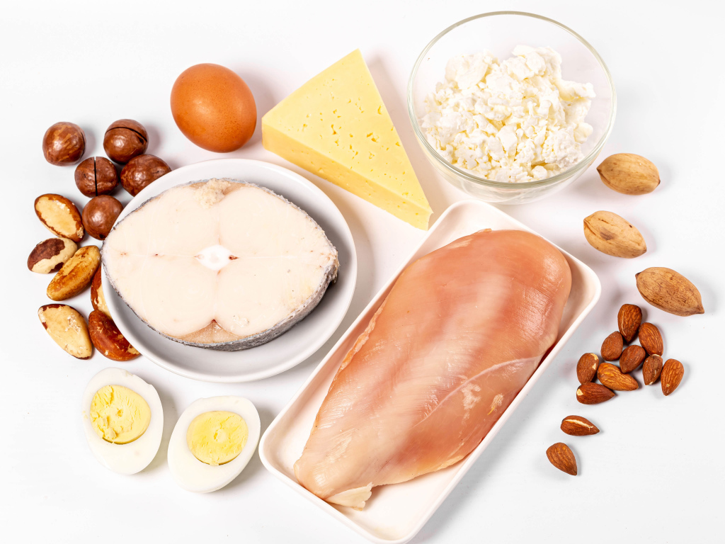 Fresh chicken, fish, nuts, cottage cheese and eggs on the table