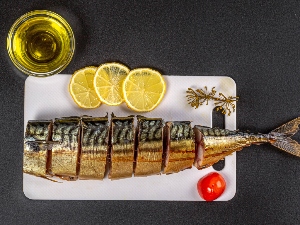 Appetizing mackerel on a board with lemon and butter