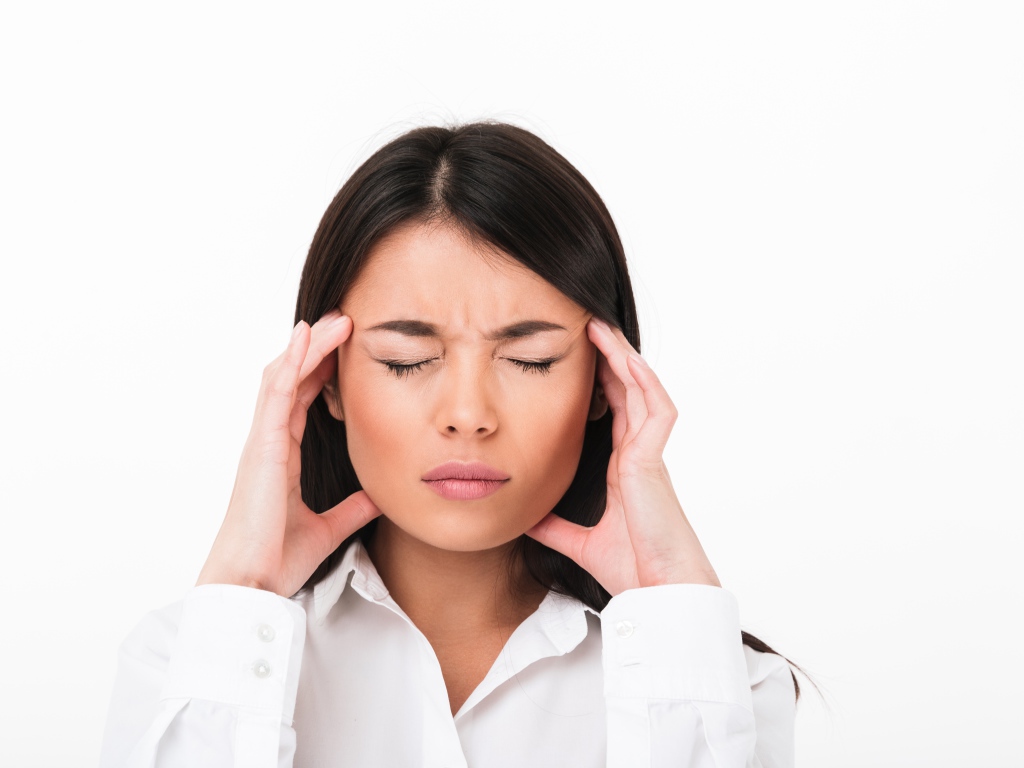 Девушка с головной болью на белом фоне 