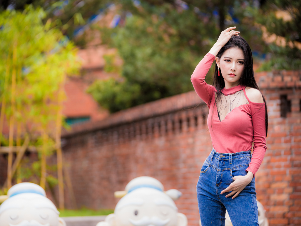 Молодая стройная азиатка в джинсах 