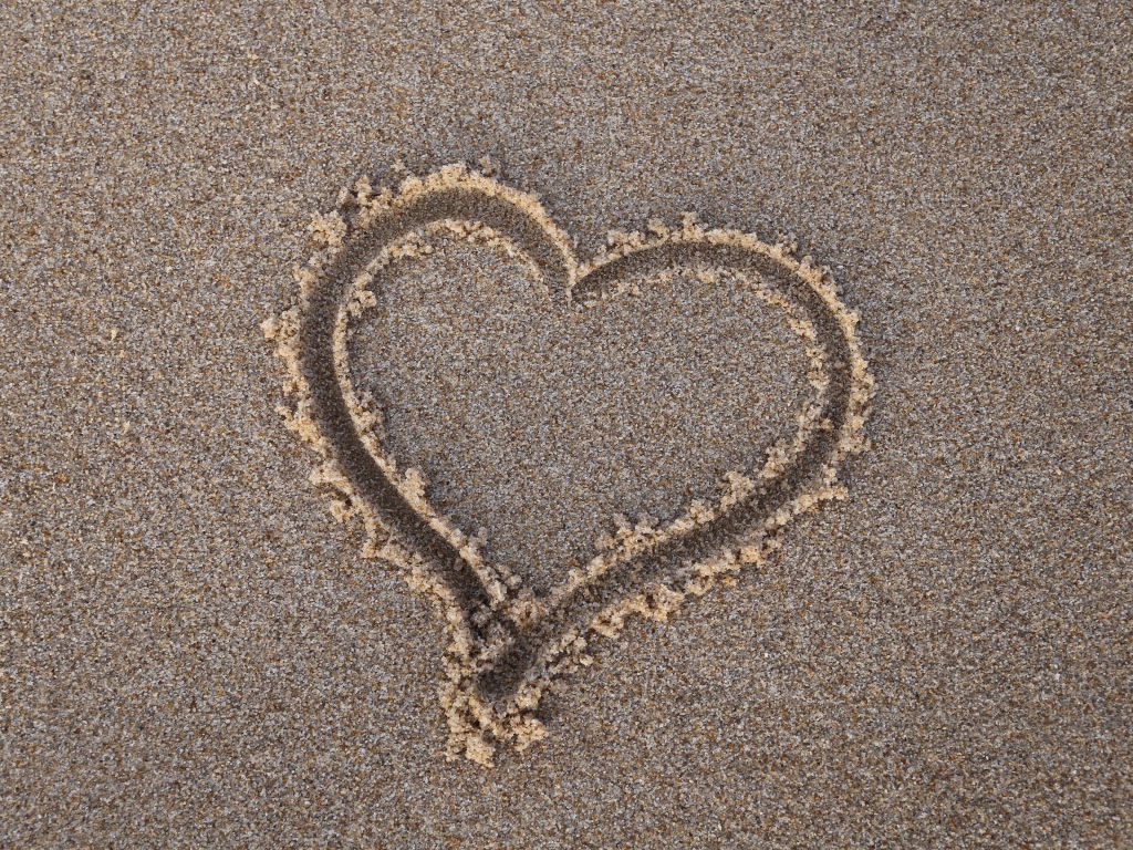 Сердце нарисовано на мокром песке 