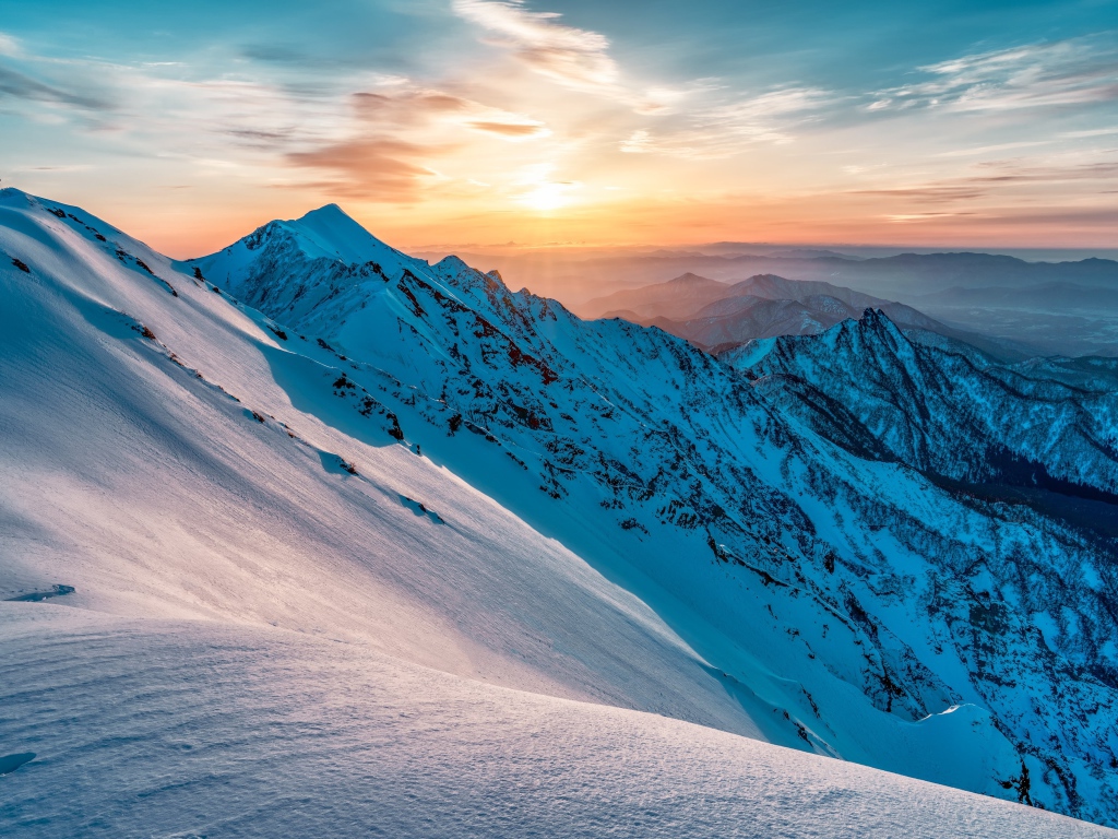 Beautiful view of the snow-capped mountains at sunrise