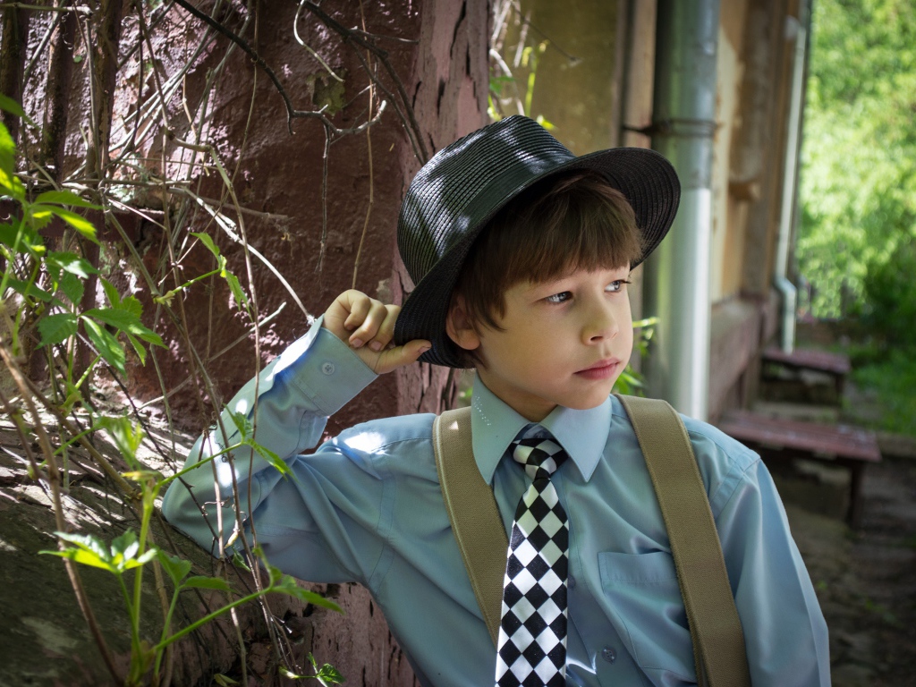 Стильный мальчик в черной шляпе 