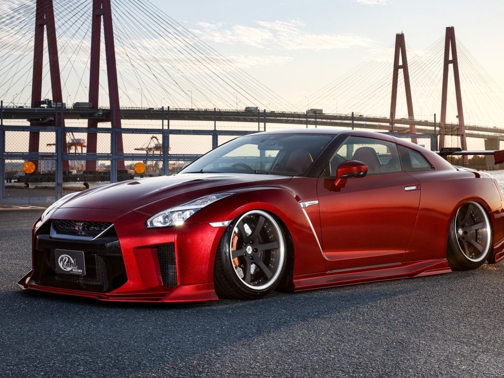 Красный автомобиль Nissan GTR 35R на фоне моста