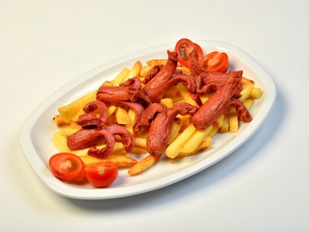 Картофель фри на тарелке с помидорами и сосисками