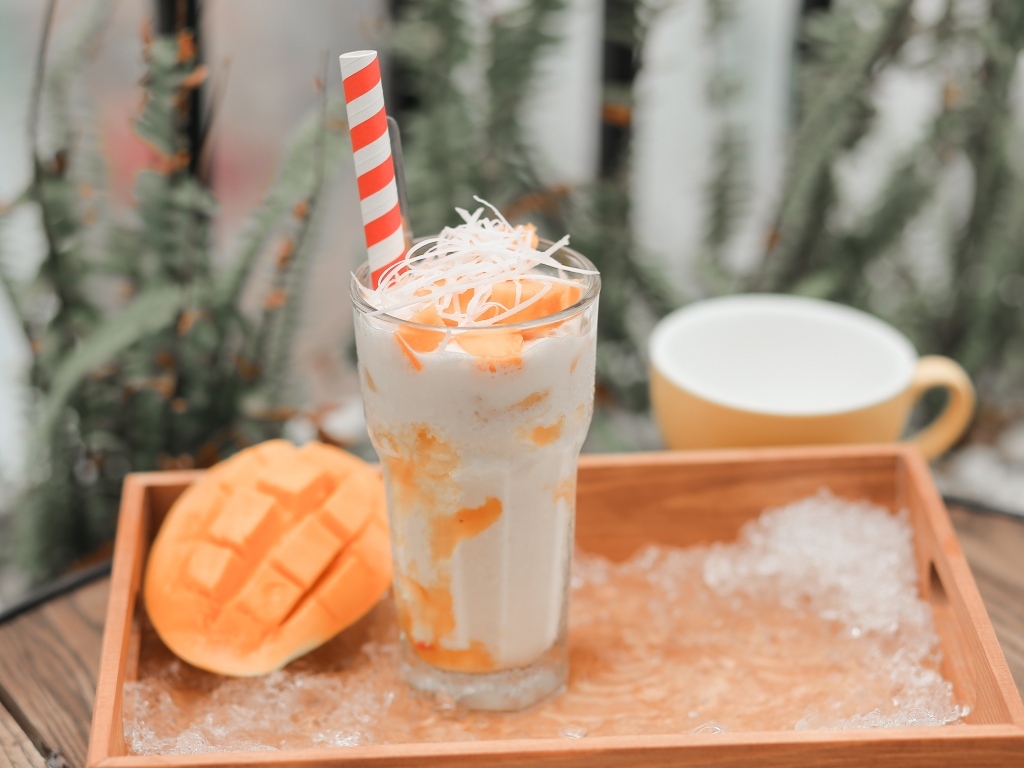 Коктейль с манго в стакане на столе