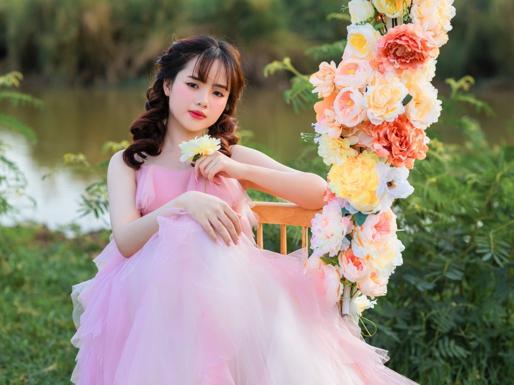 Красивая девушка азиатка в розовом платье с цветами