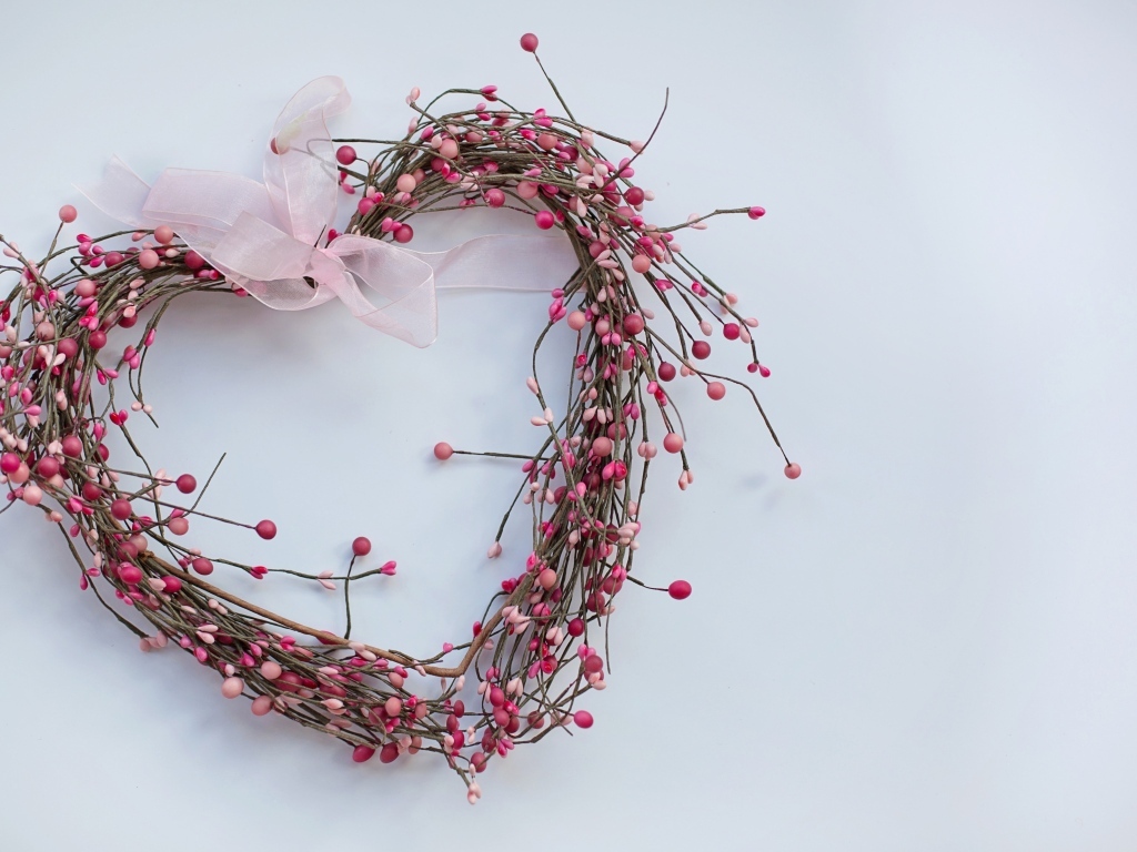 Heart from branches with a ribbon on a gray background