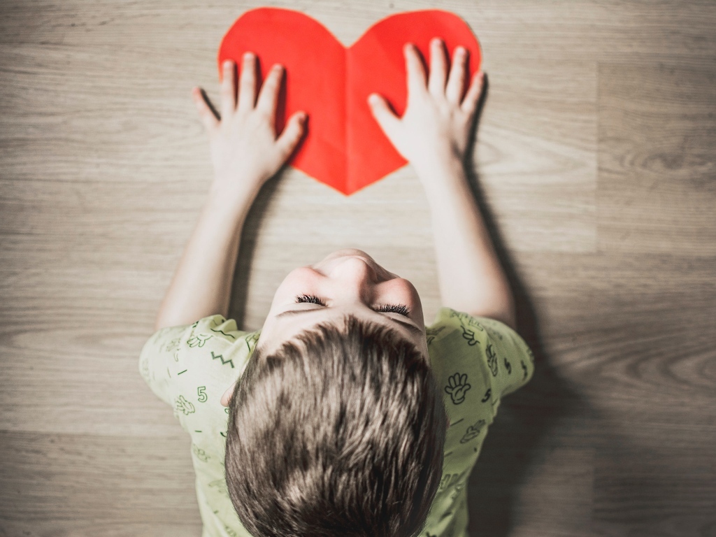 Маленький ребенок с красным сердцем