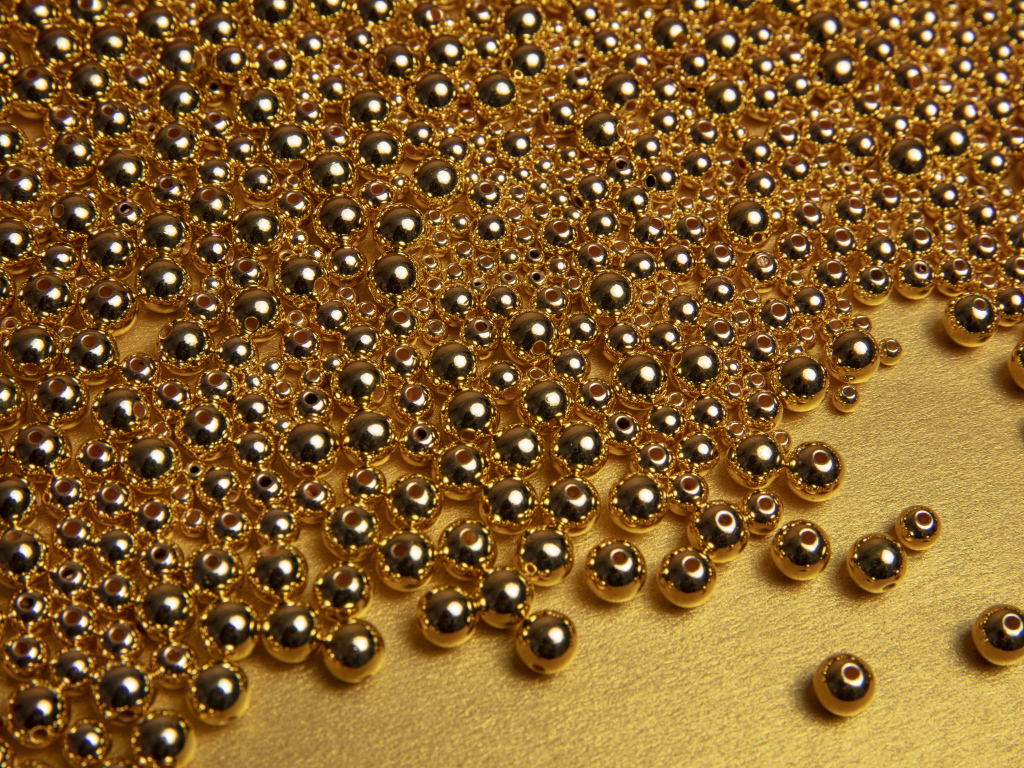 Много золотых бусин на желтом фоне