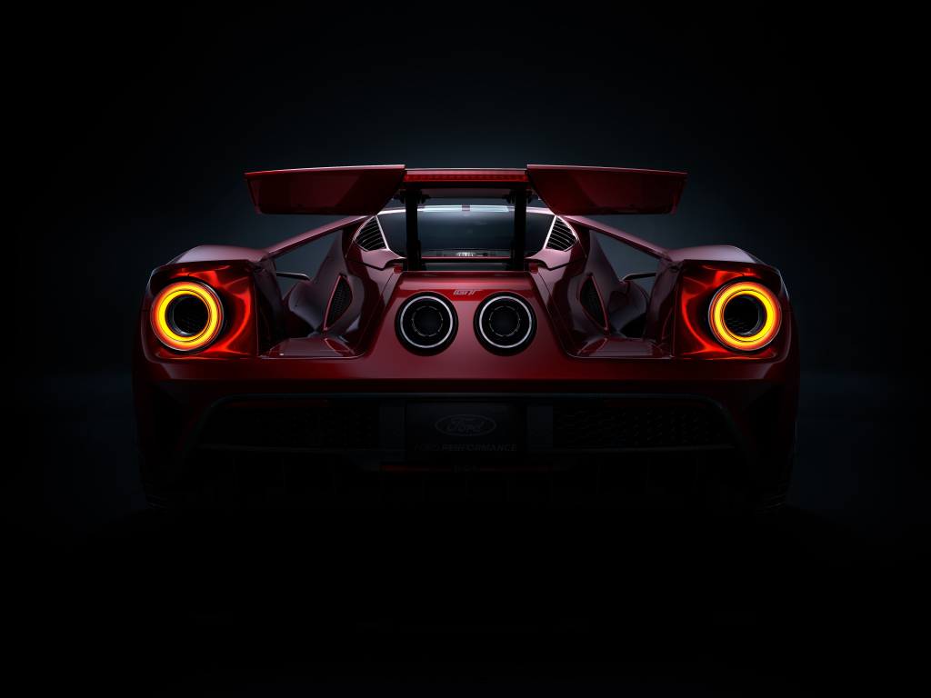 Вид сзади на автомобиль Ford GT  на черном фоне