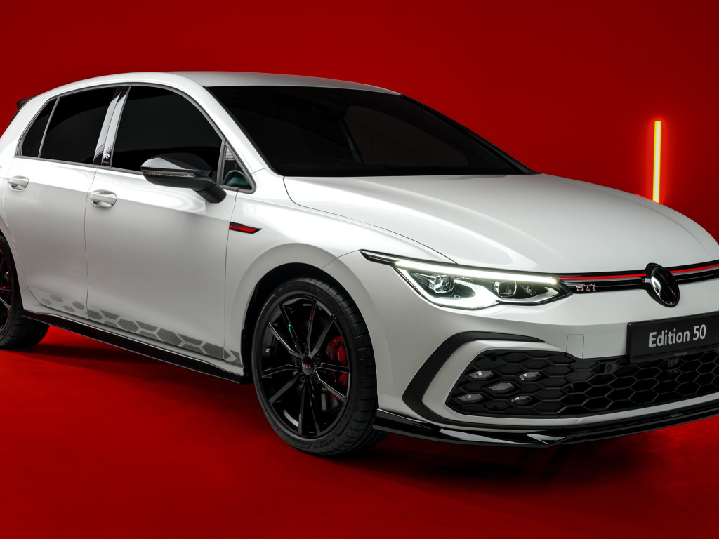 Автомобиль Volkswagen Golf GTI Edition 50 2024 года на красном фоне