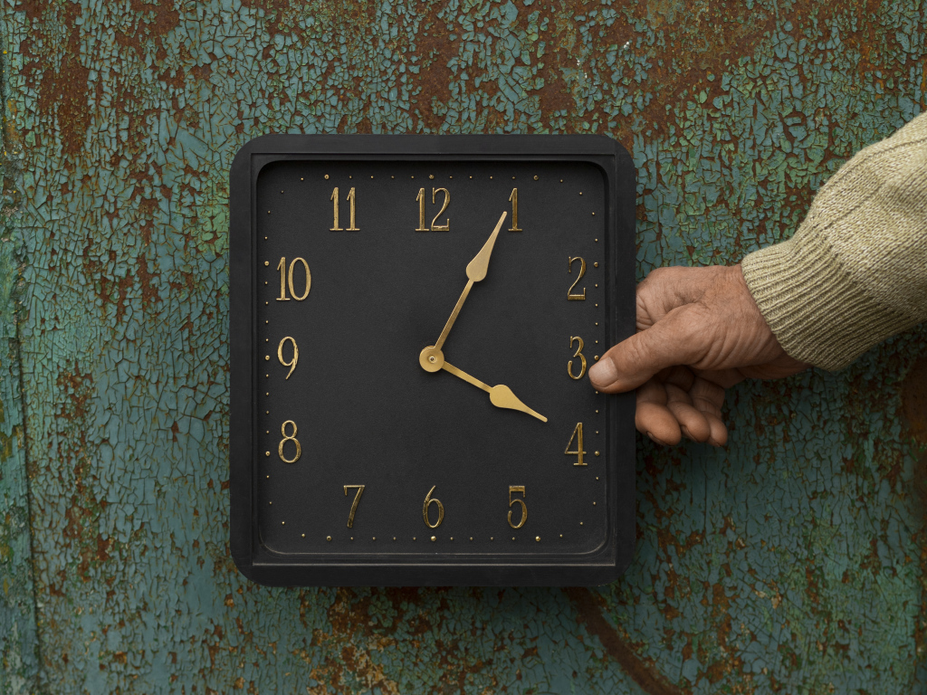 Черные квадратные часы на старой стене