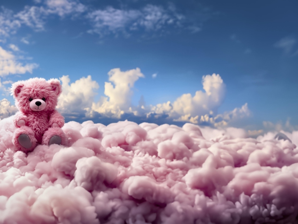 Розовый плюшевый медведь сидит на облаке