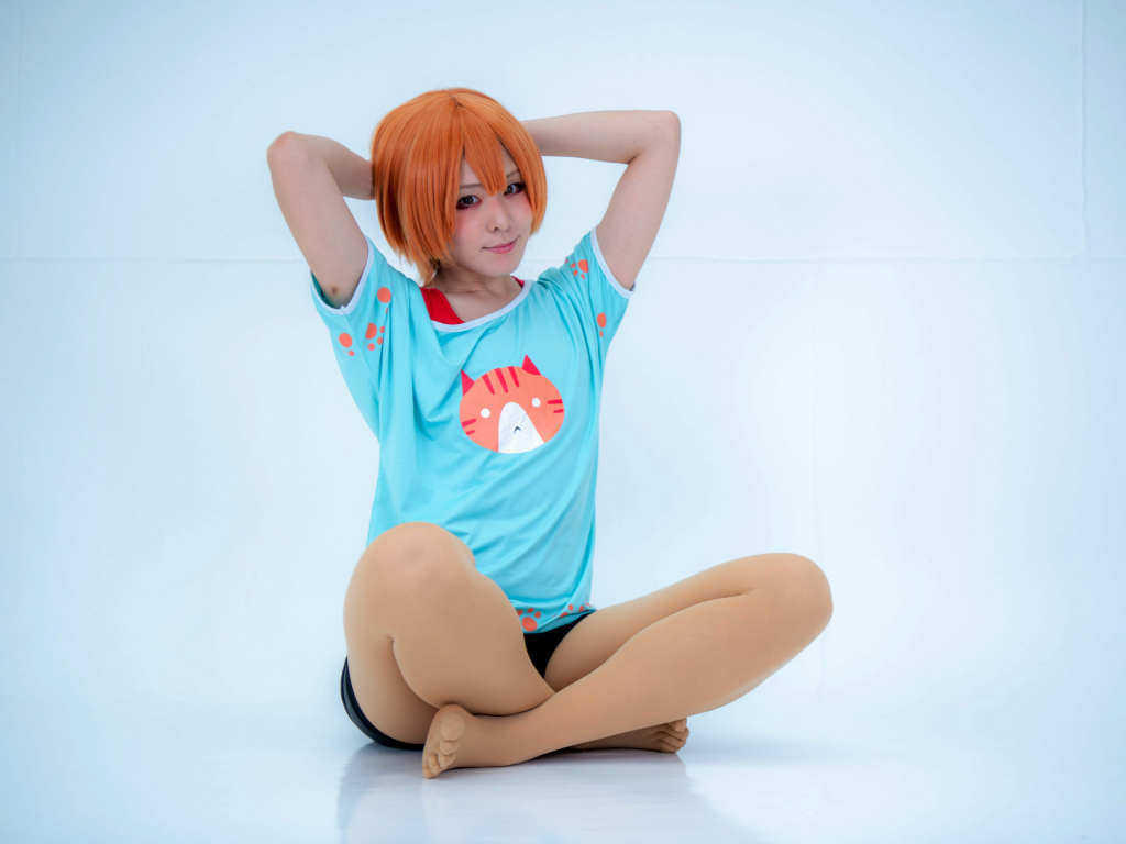 Рыжеволосая азиатка в милой футболке на голубом фоне