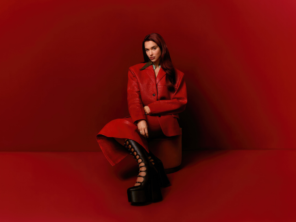 Британская певица Дуа Липа на красном фоне