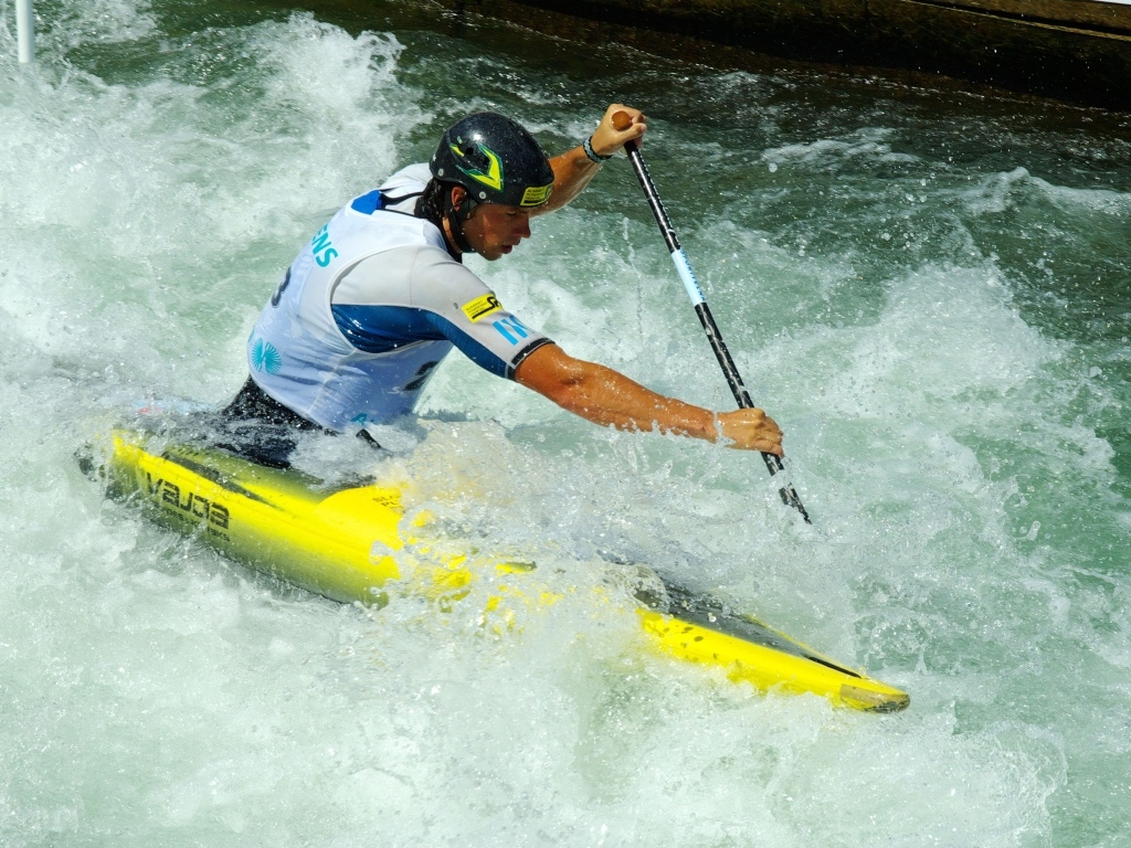 A man on a kayak goes down a stormy river