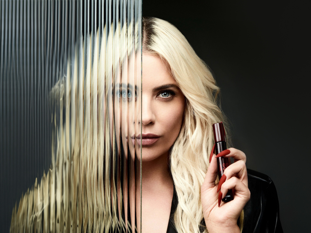 Блондинка Эшли Бенсон стоит за стеклом