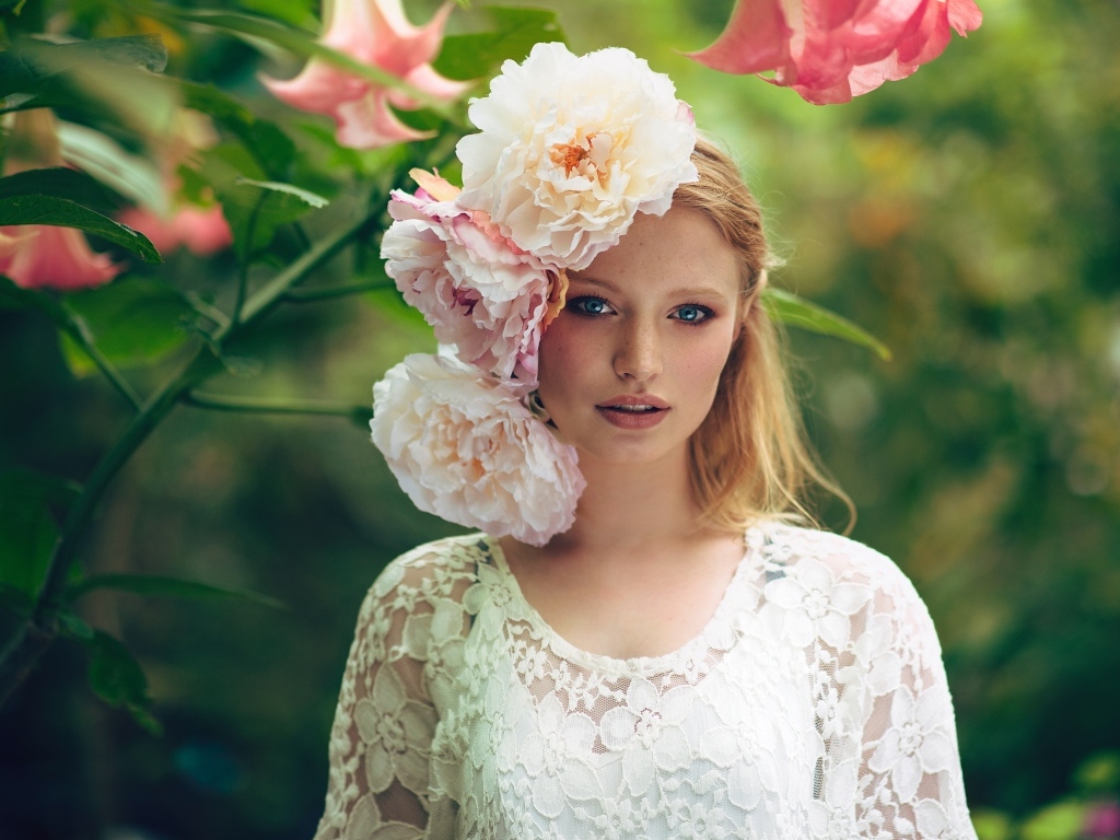 Девушка в белом платье с цветами пиона на голове