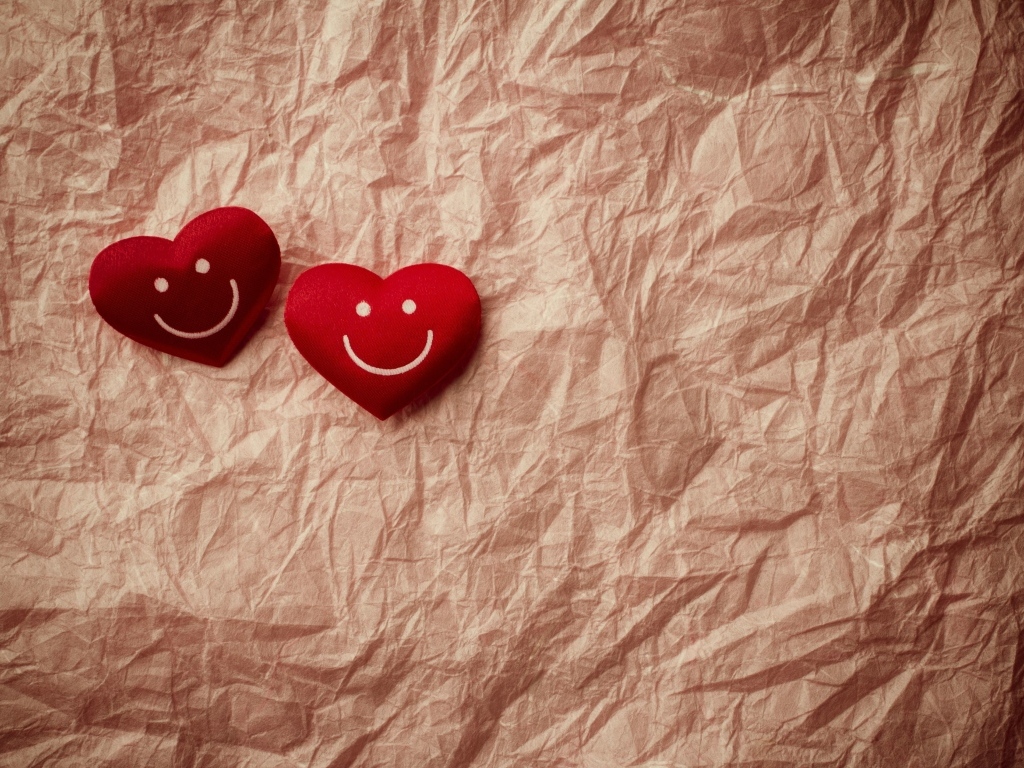 Два улыбающихся сердца на помятой бумаге