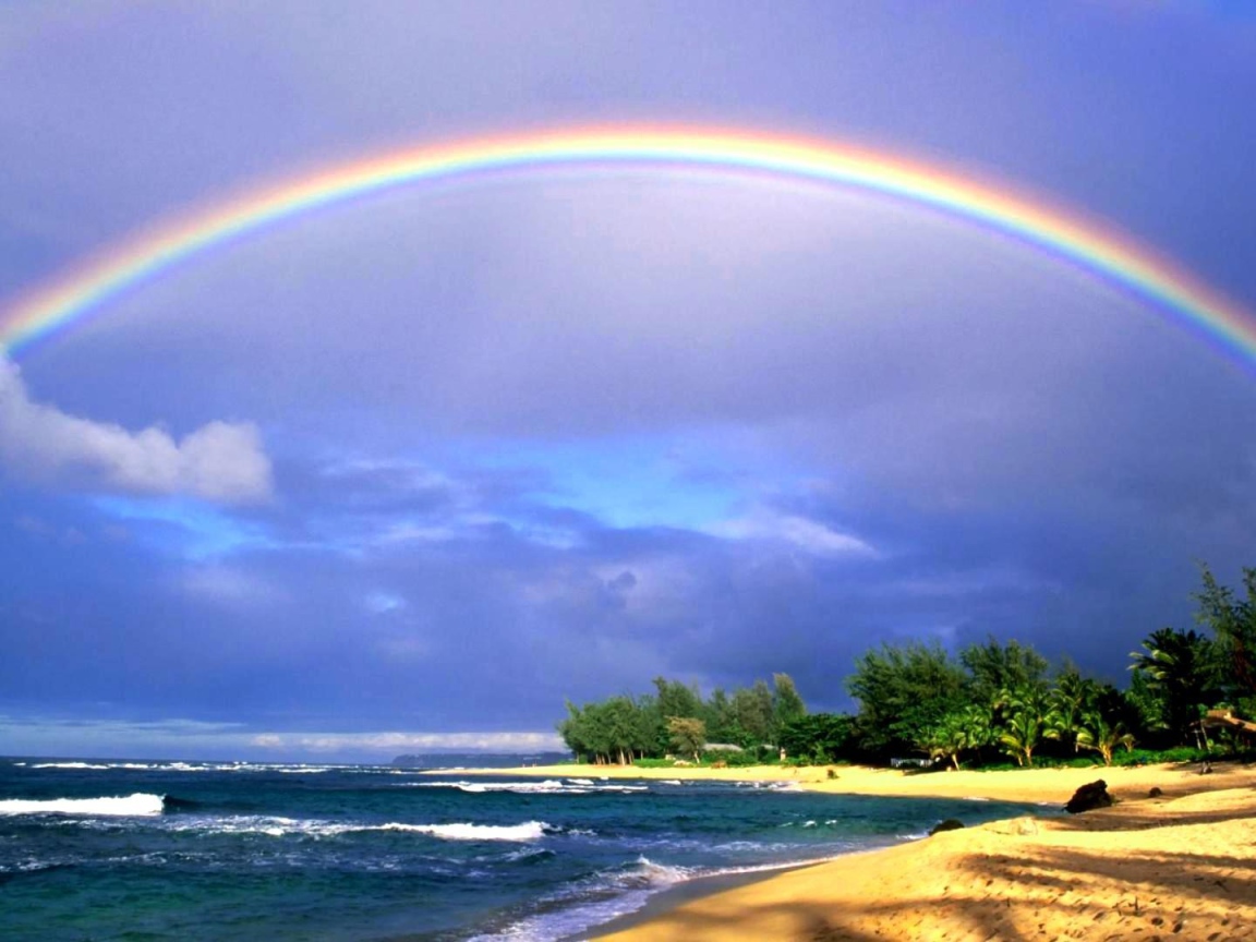 Rainbow over the sea and the beach