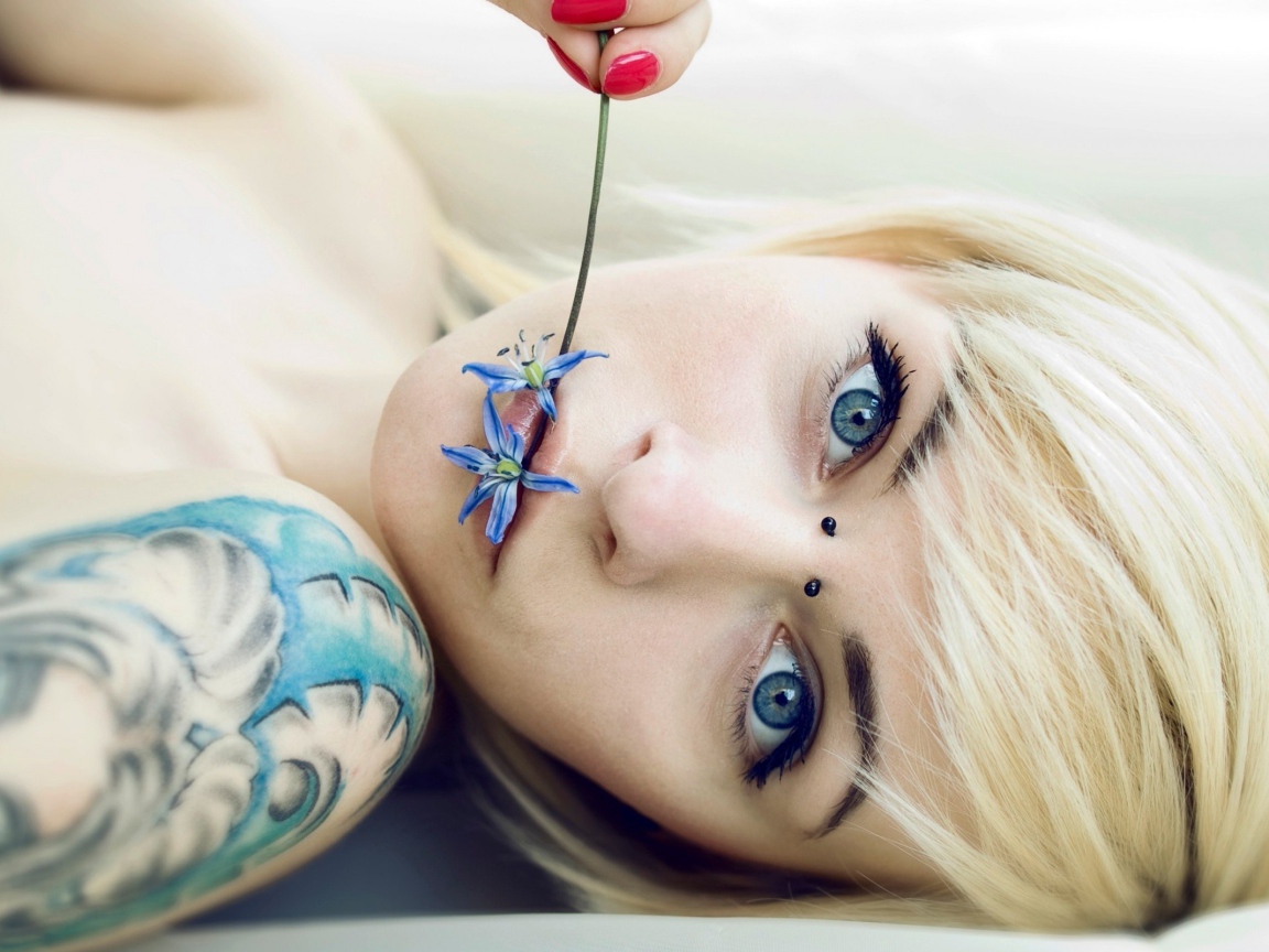 The girl with blue eyes and a beautiful tattoo